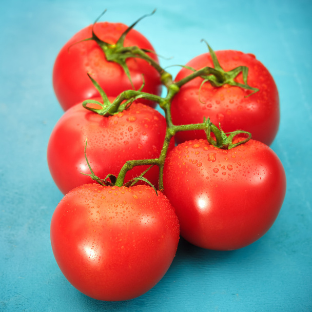 Ripe red tomatoes on blue background - Φωτογραφία, εικόνα