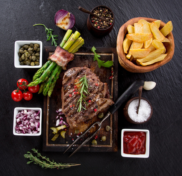 Beef steak on wooden table - Foto, Imagen