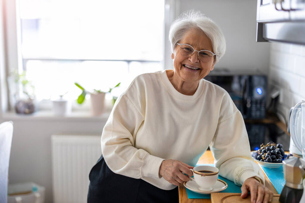 Portrait of smiling senior woman at home - Foto, Imagem