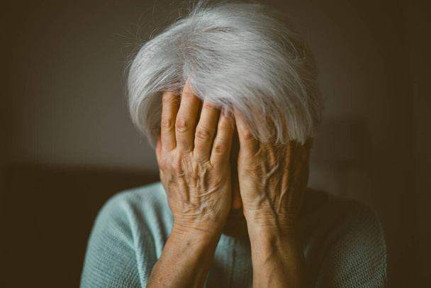 Senior woman covering face with her hands  - Fotoğraf, Görsel