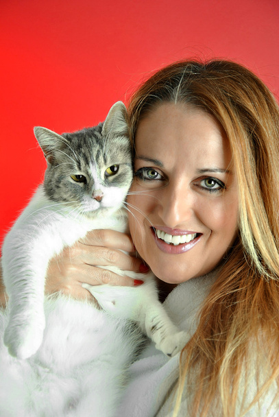 portrait of pretty woman hugging her cat - Photo, Image