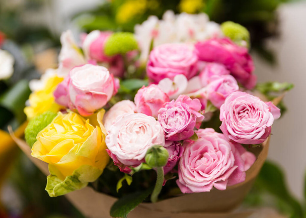A beautiful bright bouquet of blooming fresh roses for a gift collected by an experienced florist - Photo, image