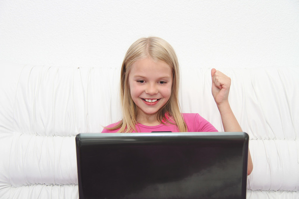 νεαρό κορίτσι που χρησιμοποιεί φορητό υπολογιστή στο σπίτι - Φωτογραφία, εικόνα