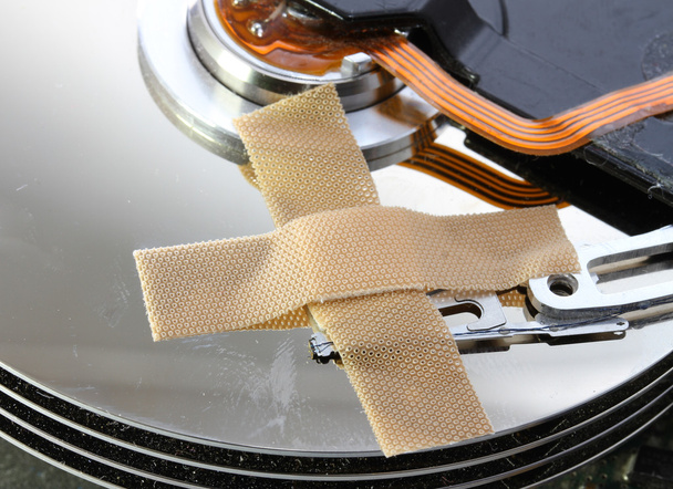 hard disk failure with a band-aid over disks - Photo, Image