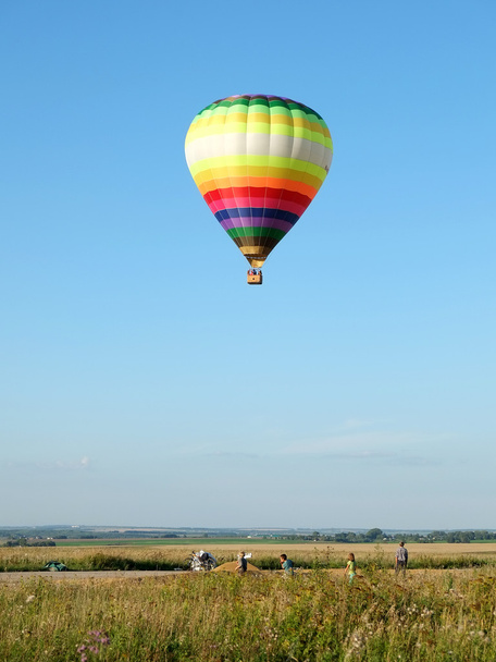 Balloon takes off in a field - 写真・画像