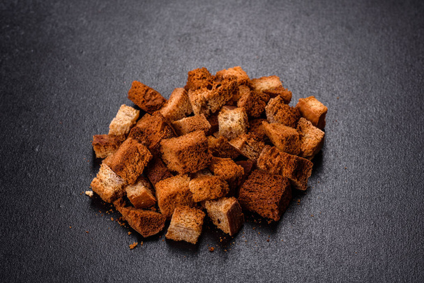 Solid, delicious breadcrumbs to the beer close-up. Dried bread with spices - Photo, Image