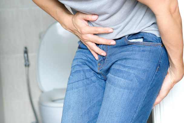 man have abdominal pain. Take a hand from the belly diarrhea.Health concept - Photo, Image