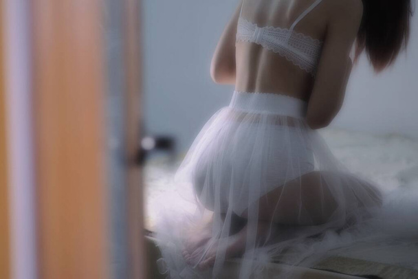 ballerina in un vestito bianco su uno sfondo di una finestra - Foto, immagini