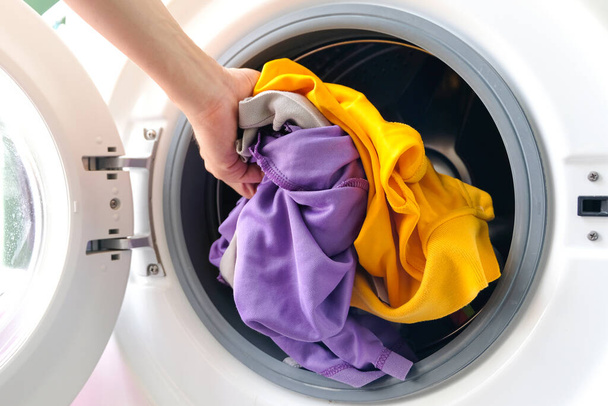 man's hand Pick up clothes Washing machine.Clean and Healthy Concepts - Foto, Imagem