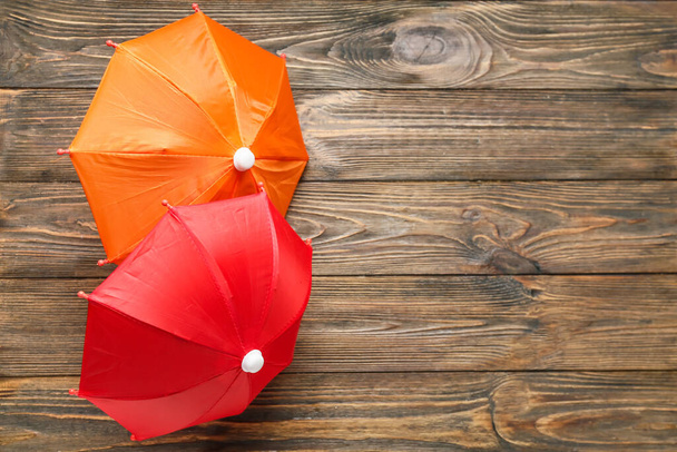Open umbrellas on wooden background - Photo, Image