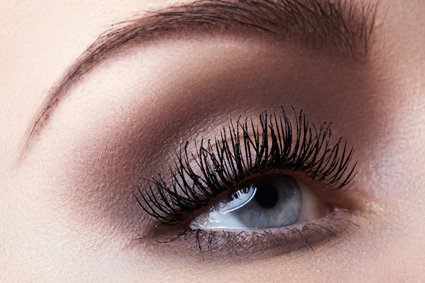 Macro shot of woman's beautiful eye with extremely long eyelashes. Sexy view, sensual look - Zdjęcie, obraz