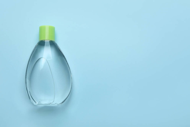 Bottle of baby oil on light blue background, top view. Space for text - Фото, зображення