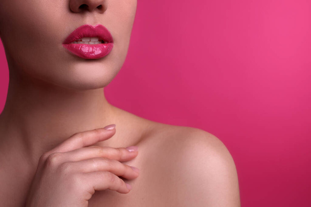 Closeup view of woman with beautiful full lips on pink background, space for text - Fotoğraf, Görsel