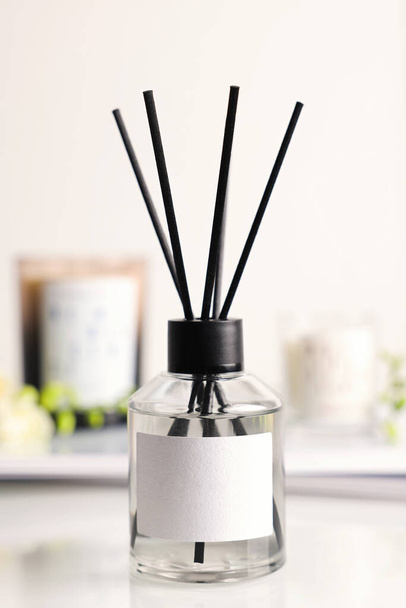 Aromatic reed air freshener on white table, closeup - Foto, imagen