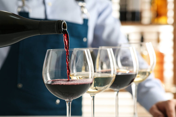 Bartender pouring wine into glass in restaurant, closeup - Fotoğraf, Görsel