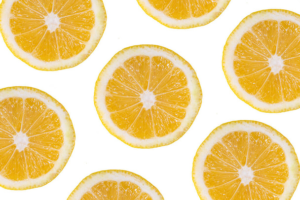 白の背景に新鮮な黄色のレモンのパターンのスライス。トレンディーなポップアート高色の明るいフラットレイとレモンの半分 - 写真・画像