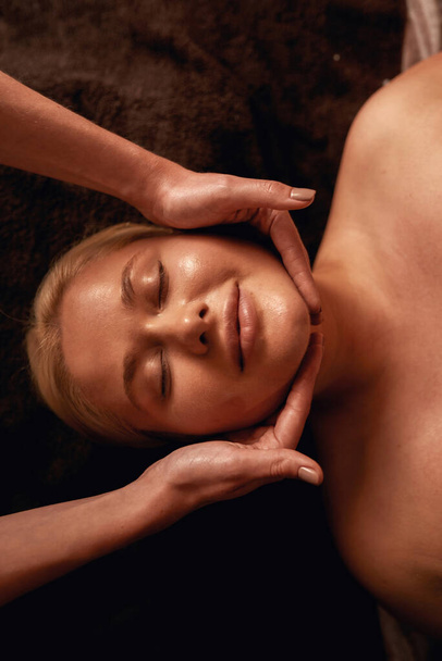 Masseur do face massage of caucasian woman in spa - 写真・画像