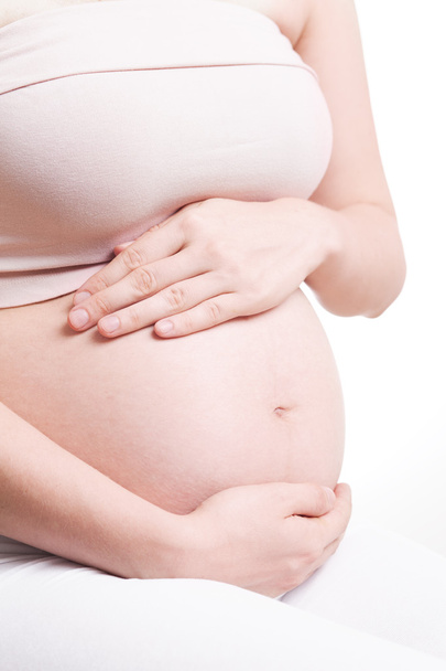 Pregnant woman with hands over tummy at white background - Φωτογραφία, εικόνα