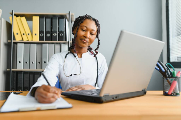 African female doctor make online telemedicine video call consult patient. Afro american black woman therapist talking to camera in remote videoconference chat. Webcam view, face headshot - Photo, image