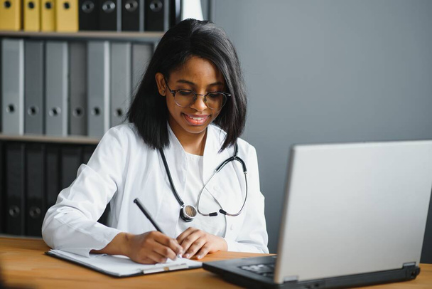 Portrait Of Smiling Female Doctor Wearing White Coat With Stethoscope In Hospital Office - Foto, Imagem