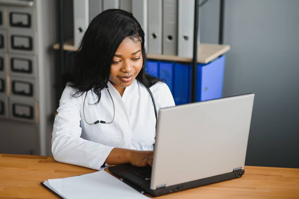 healthcare, medical and technology concept - african female doctor with laptop. - Photo, Image