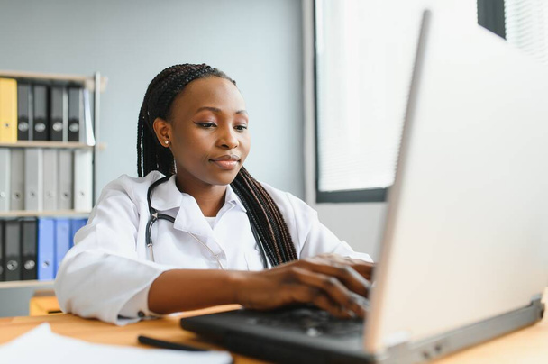 African female doctor make online telemedicine video call consult patient. Afro american black woman therapist talking to camera in remote videoconference chat. Webcam view, face headshot - Foto, Bild