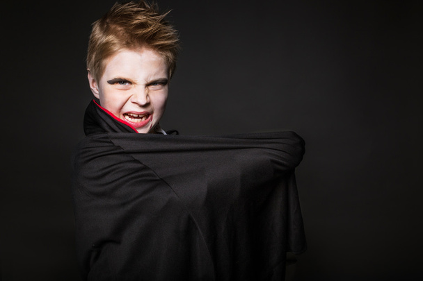 Cute boy dressed up as vampire for the halloween party - Photo, Image
