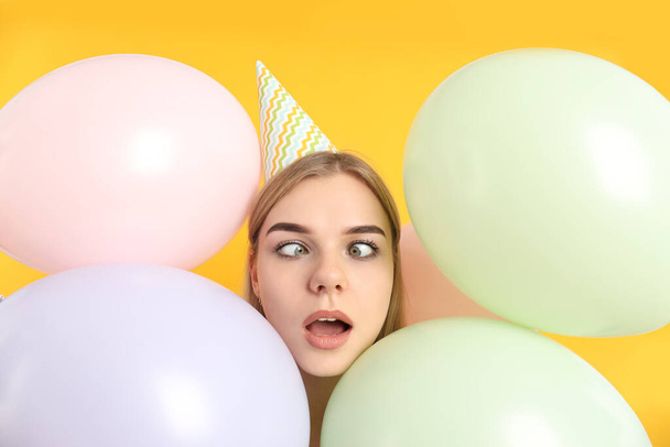 Concept of Happy Birthday with young woman on yellow background - Фото, изображение