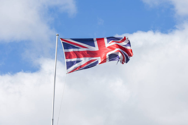 Union Jack flag of United Kingdom flyiing with ripped edges - Zdjęcie, obraz
