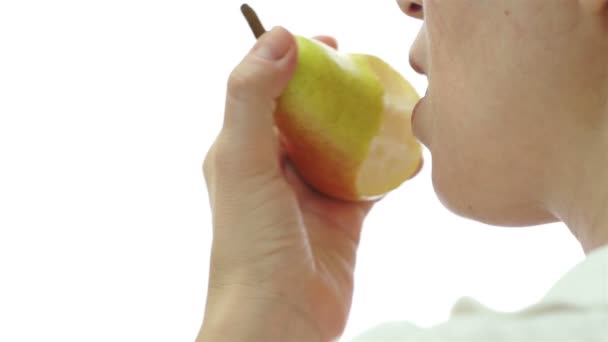 Female Eating Pear Over Shoulder - Filmati, video