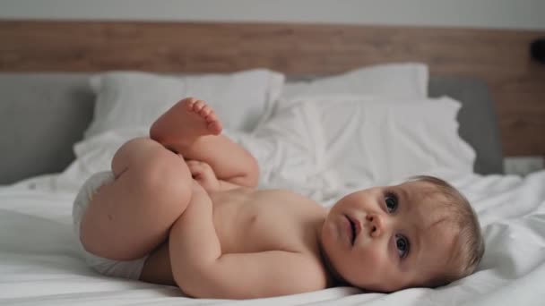 Videó aranyos kislányról a fürdés után az ágyon fekve. Lövés RED hélium kamerával 8K-ban.  - Felvétel, videó