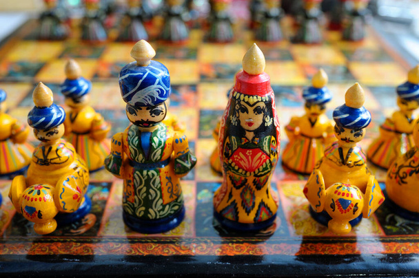 Chess pieces made in traditional Tajik style dressed in folk costumes. - Photo, Image