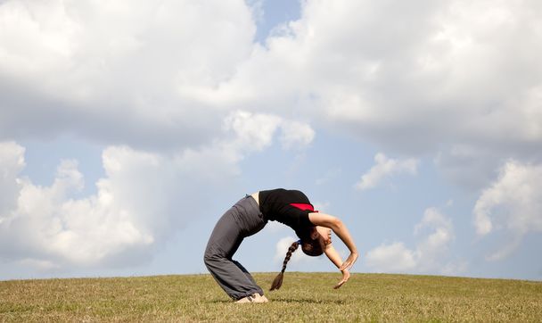 Girl make yoga at meadow. - Photo, Image