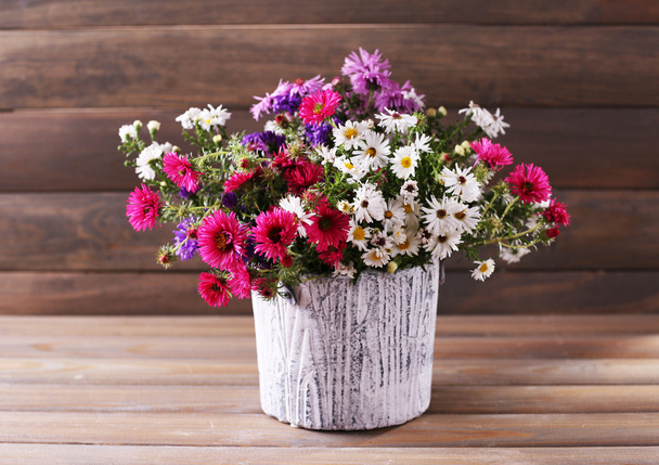 Still life of beautiful flowers in vase on wooden background   - Foto, immagini