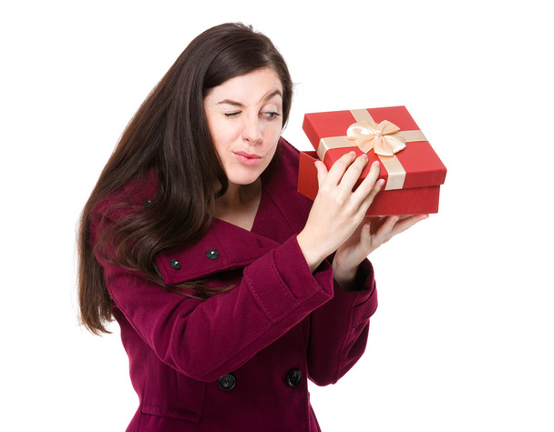 Woman looking at gift box - Фото, изображение