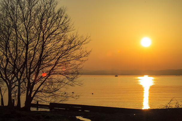 puesta de sol junto al lago
 - Foto, imagen