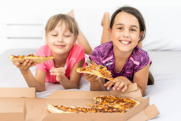 Attractive little girls posing with pizza boxes - Photo, Image