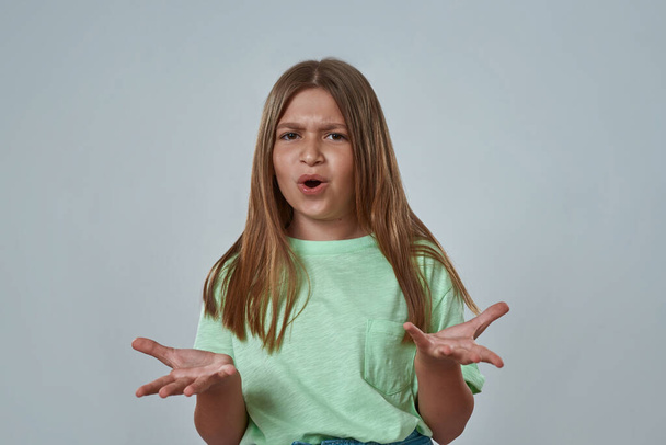 Girl with open mouth and arms with skeptical face - Foto, Bild