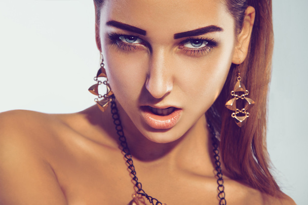 Angry fashion model in studio with professional make up accessor - Zdjęcie, obraz