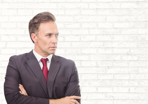 Caucasian businessman with arms crossed against copy space on brick wall background. business and technology concept - Photo, image