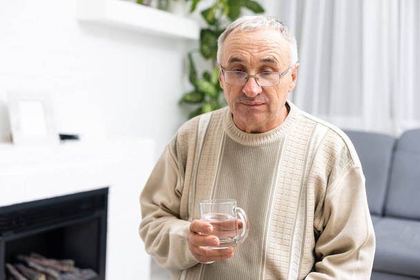 Male senior citizen in shirt drinking water - Zdjęcie, obraz