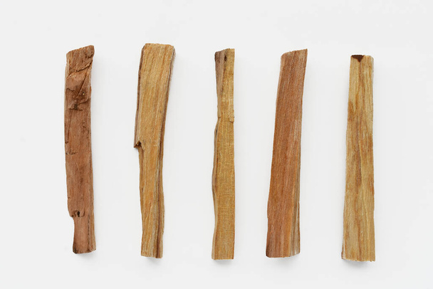 Una imagen de vista superior de varios palos de incienso de madera santa sobre un fondo blanco.  - Foto, Imagen