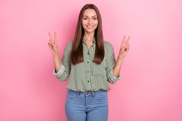 Photo of adorable sweet lady dressed green shirt showing two v-signs smiling isolated pink color background - Foto, Imagem