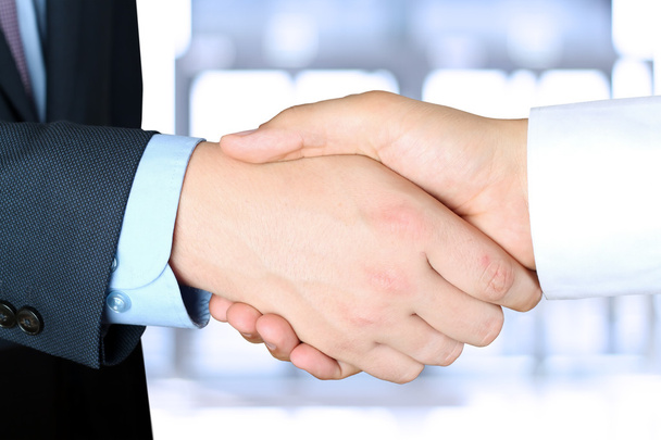 Close-up image of a firm handshake  between two colleagues outsi - Foto, afbeelding