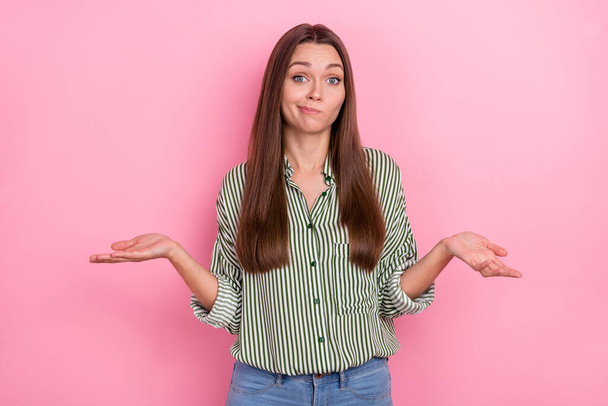 Photo of funny puzzled woman wear striped shirt shrugging shoulders isolated pink color background - Φωτογραφία, εικόνα