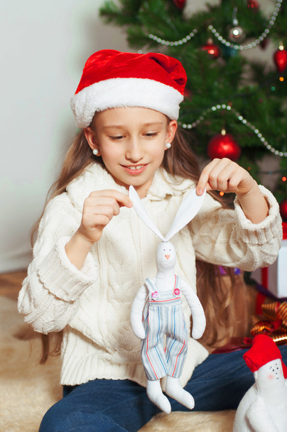 Little girl with long hair near  Christmas tree - Фото, зображення