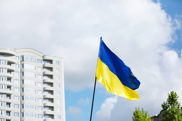 Big national flag of Ukraine on city street - Foto, imagen
