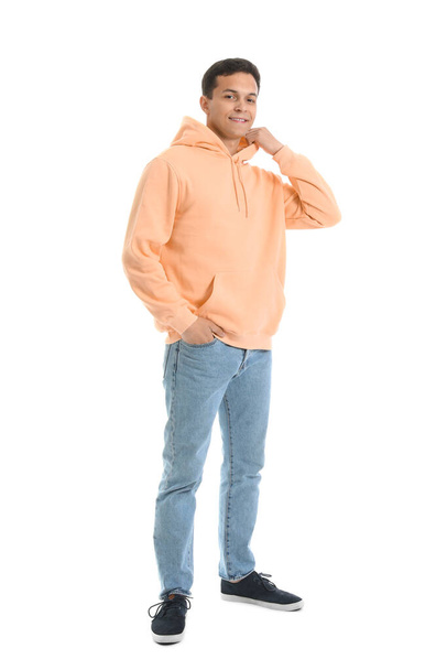 Young man in orange hoodie on white background - Φωτογραφία, εικόνα