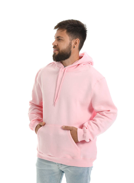 Handsome man in pink hoodie on white background - Foto, Imagen