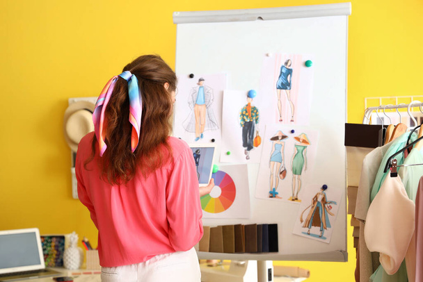 Young female clothes stylist working in studio - Photo, Image